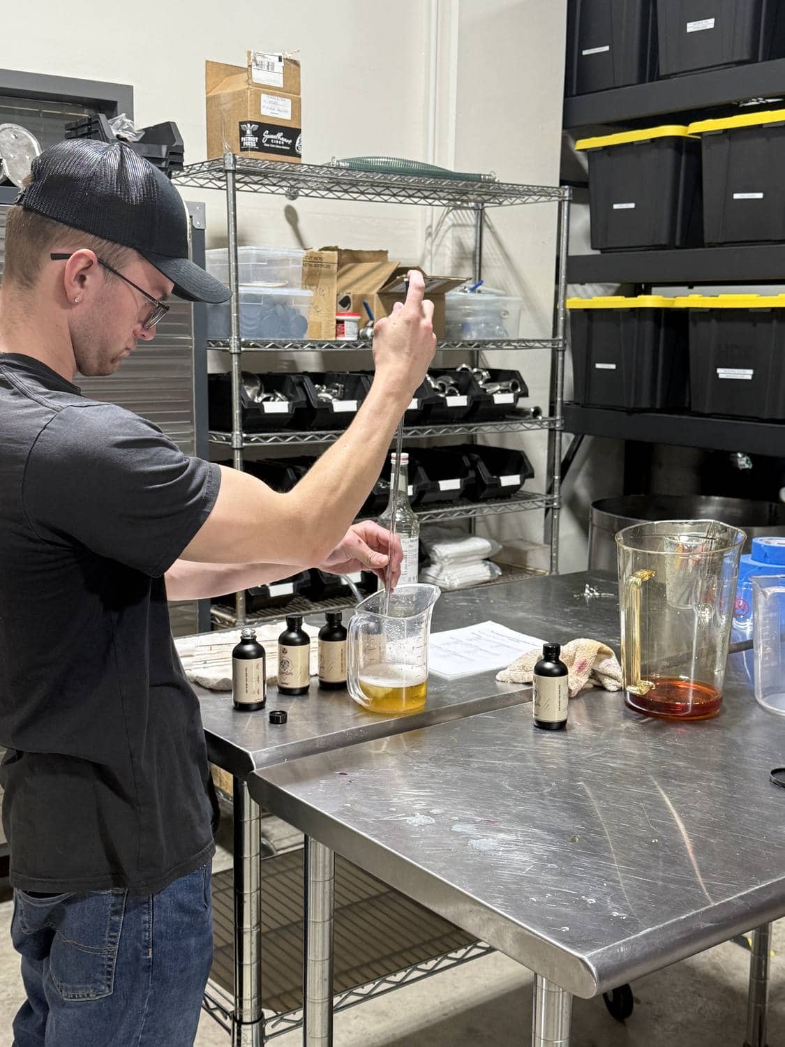 A winemaker drawing a sample to check a batch