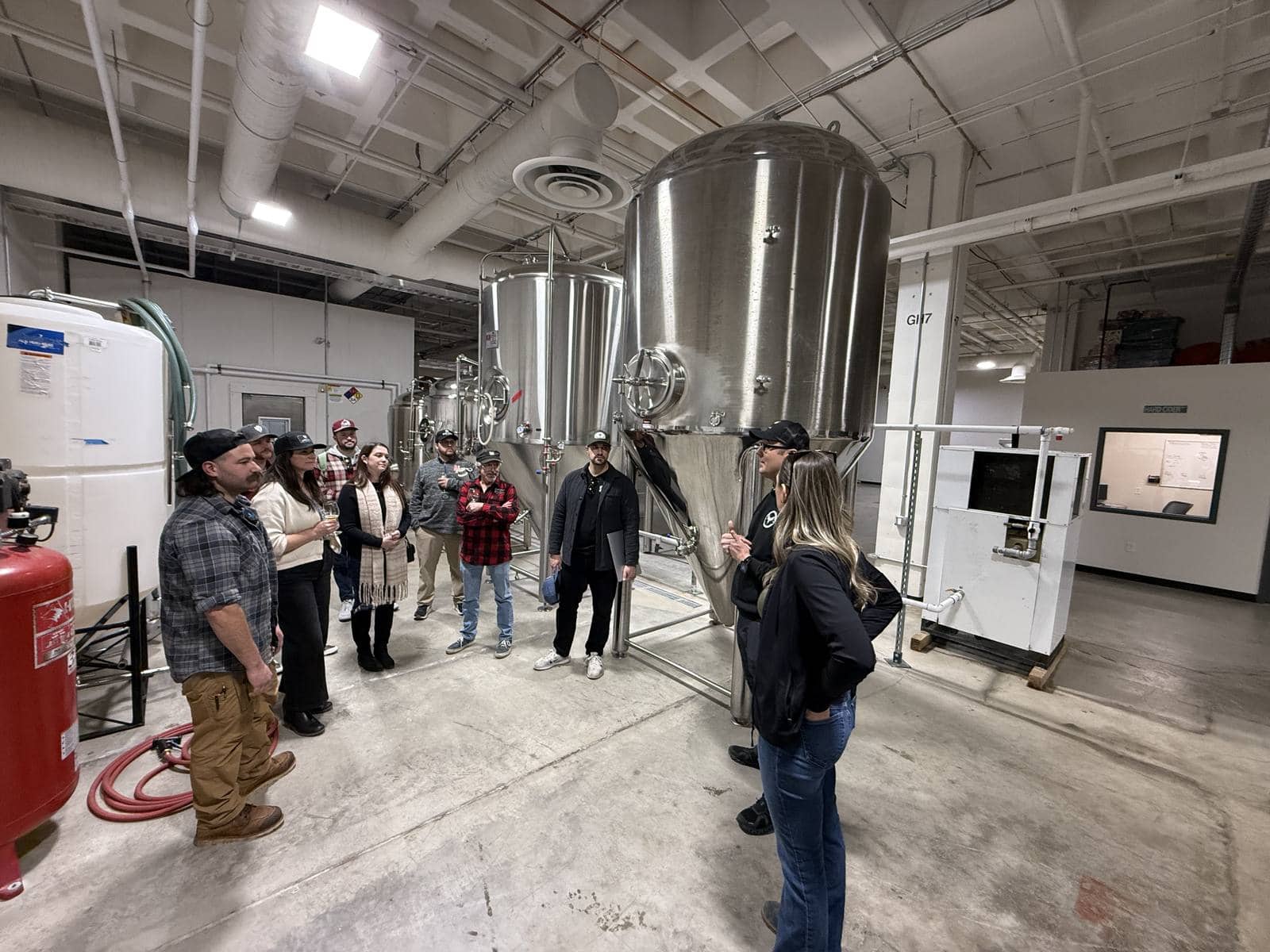 A tour group gathered around a tank in the cellar